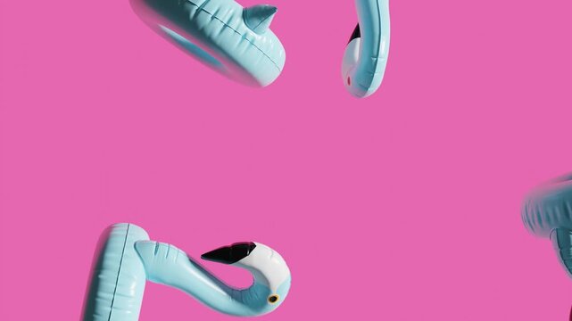 Falling inflatable flamingos motion graphics on pink background. 3d loops animation