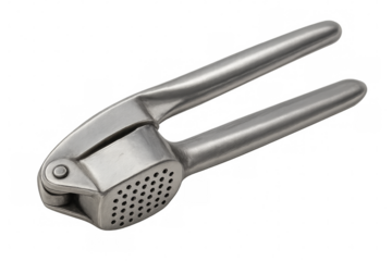 Metal garlic press crushing garlic cloves on transparent background