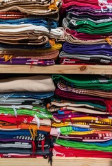 Stack of colorful handcrafted textile blankets at a local fair in mexico