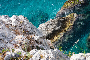 Stunning view of Calella de Palafrugell's pristine coastline featuring traditional whitewashed Mediterranean architecture, crystal-clear turquoise waters, and dramatic rocky outcrops along Costa Brava