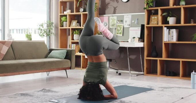 Woman, yoga and headstand in home, meditation and balance for circulation, brain or benefit in lounge. Person, sirsasana and back with routine on floor, strength training and stretching at apartment