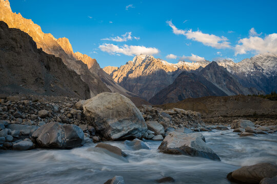 The Hunza River flows through the valley near rainbow bridge in Pasu, Hunza Valley in the Gilgit-Baltistan region of northern Pakistan