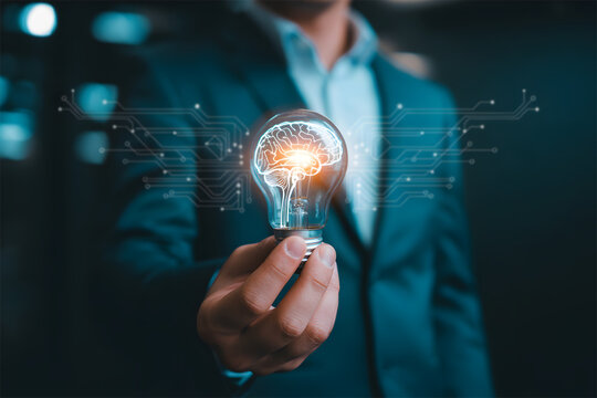 Brilliant business mind holding bright idea lightbulb for innovation and technology solutions, showcasing creative and modern thinking