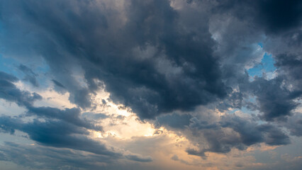Beautiful Sky Background. Sunset Sunrise Sky with Storm Clouds and Real Sun