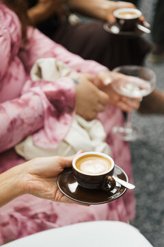 womans hands holding a cup of coffee
