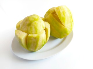 
Fresh Sliced Ambarella Fruit with Spicy Seasoning on Plate