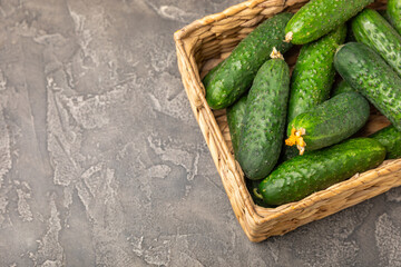 Cucumber on wooden background. Slice of cucumber on background. Fresh organic green cucumbers gherkin. Vegan. Salad ingredient. Farm vegetables. Cut vegetables with knife. Space for text. Copy space