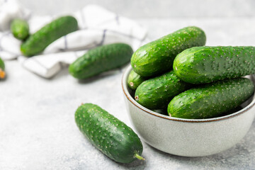 Cucumber on wooden background. Slice of cucumber on background. Fresh organic green cucumbers gherkin. Vegan. Salad ingredient. Farm vegetables. Cut vegetables with knife. Space for text. Copy space