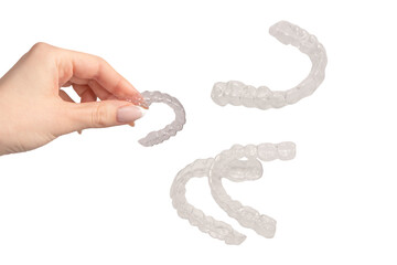 Transparent mouth guard in a woman's hand isolated.
