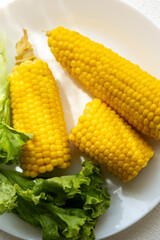Close-up of boiled corn on a white plate