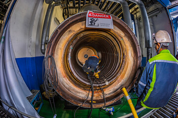 Welding male worker metal is part of machinery boiler coil tank construction repair inside