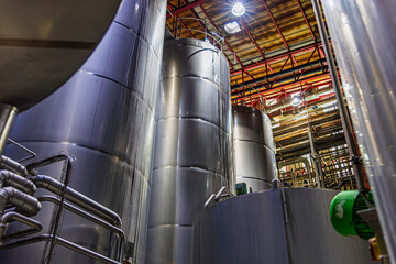 Stainless vertical steel tanks and pipes with pressure meter in equipment tank chemical cellar at the with stainless steel