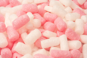 Pink and white box filler as a background. Top view.