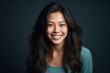 Fototapeta premium Smiling young woman portrait studio photography dark background close-up confidence and joy