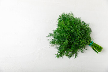 Dill on wooden background. Fresh organic greens. Dill plantation. Cut dill leaves. Bunch of spring young dill. Vitamins. Fiber. Aromatic culinary spice. Place for text. Copy space