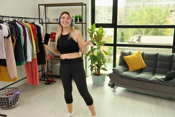 Dancing at home while listening to music in a stylish urban apartment with vibrant decor