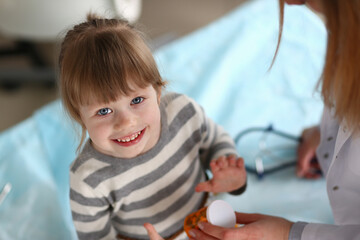 Joyful child interacting with caring adult in a bright, friendly environment during a health check-up