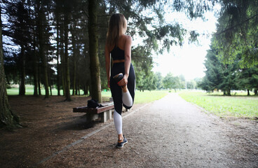 Stretching and warming up in a serene park on a fresh morning before an invigorating workout session