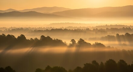 Sunrise through morning mist over layered hills and forests.