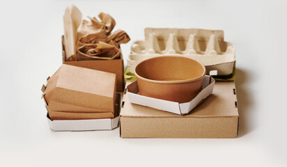 Sorting garbage for recycling on white background. Cardboard waste segregation, paper waste sorting, waste recycle. Garbage separation concept.