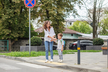 Mother teaching son road safety at crosswalk