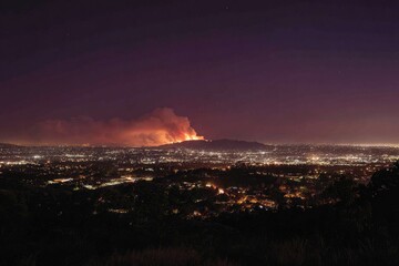 Nighttime cityscape with large wildfire