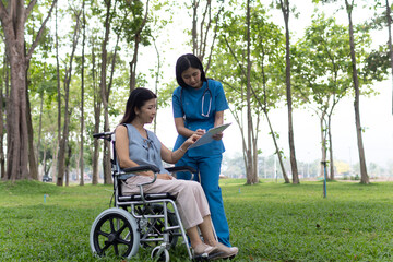 A friendly nurse assists an elderly woman in a wheelchair, providing care, support, and conversation during recovery in a retirement or healthcare setting.