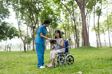 Fototapeta premium A friendly nurse assists an elderly woman in a wheelchair, providing care, support, and conversation during recovery in a retirement or healthcare setting.