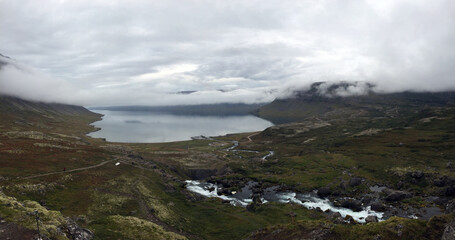 Icelandic fjord landscape with river stream and low clouds near Dynjandi waterfall