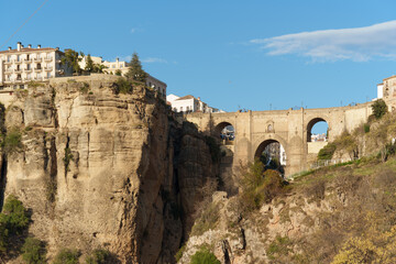 old bridge Bridge over the river in the town of Ronda, next to a rocky cliff