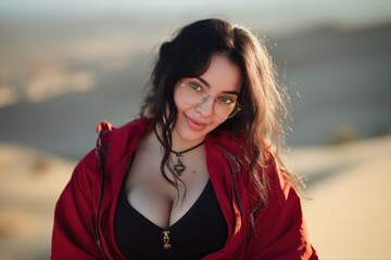 Fototapeta premium Young caucasian female smiling in red jacket on a sunny day outdoors