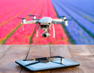 Drone Flying Over Pink and Purple Flower Fields with Tablet on Wooden Table