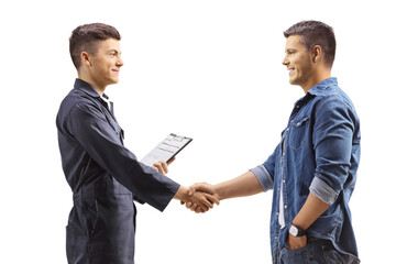 Young mechanic shaking hands with a casual man