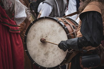 A medieval drummer stands holding a traditional drum and sticks during the coronation reenactment of Charles III of Hungary