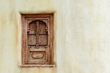Old Carved Wooden Window on Beige Wall