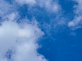 Clear Blue Sky with White Fluffy Clouds on a Sunny Day