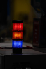Red, yellow, blue led industrial light tower in a factory indicating the work in progress.