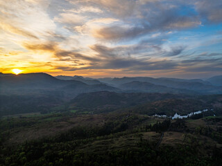 Sunset over Mountains and Coniston Water from drone, Lake District National Park, Cumbria, England	