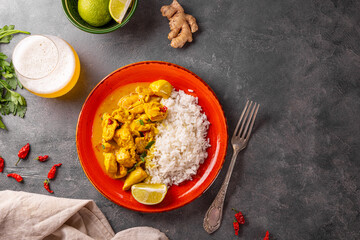 Chicken in curry sauce and rice on grey background, Indian food top view copy space for text