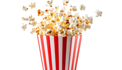 A classic red and white striped box of freshly popped yellow corn sits next to a glass full of the delicious movie theater snack on White