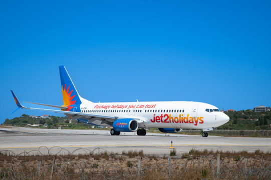 26 July 2025. Skiathos, Greece. Jet2holidays Boeing 737 G-JZHN taxiing on the runway at Skiathos Airport, with colourful livery and holiday branding under a clear blue sky.