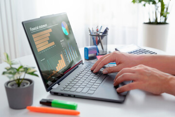 Fototapeta premium Man using 2 in 1 laptop to financial data analysis