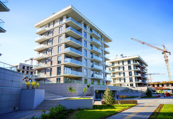 Hotel construction. Tower crane on building construction. Multi Storey Residential Buildings construction. Green courtyard at Condominium. Cityscape of residential area with modern apartment buildings © MaxSafaniuk