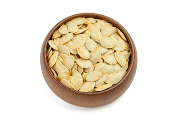 Natural pumpkin seeds displayed in a round wooden bowl, showcasing their light beige color and smooth texture, perfect for healthy snacking or culinary use