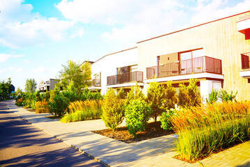 Landscaping design for backyard garden. Ornamental grass, arborvitae, flowerbed, deciduous shrubs in urbanization. Landscape design in duplex condominium. Duplex Townhouse in Urban Ecosystem. © MaxSafaniuk