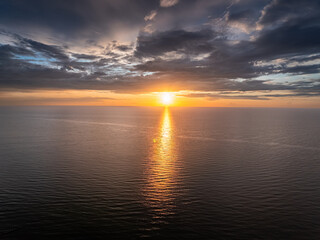 Calm sea waves illuminated by sunset in Poland.