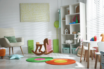 Stylish playroom with toys and furniture. Interior design