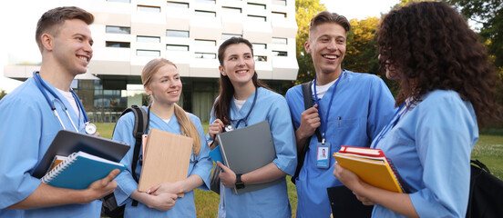 Group of medical students in uniforms near building outdoors