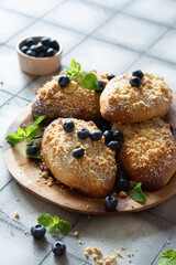 Buns with berry filling, blueberries and mint on a gray background. Polish dessert Jagodzianki 