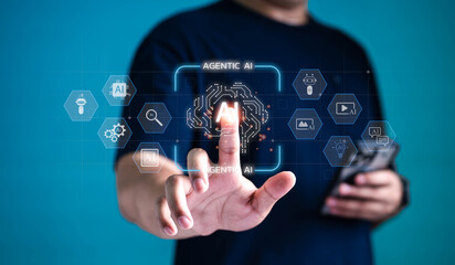 Businessman using futuristic interface to activate AGENTIC AI technology with fingertip. Innovative artificial intelligence system, automation, and machine learning concept.